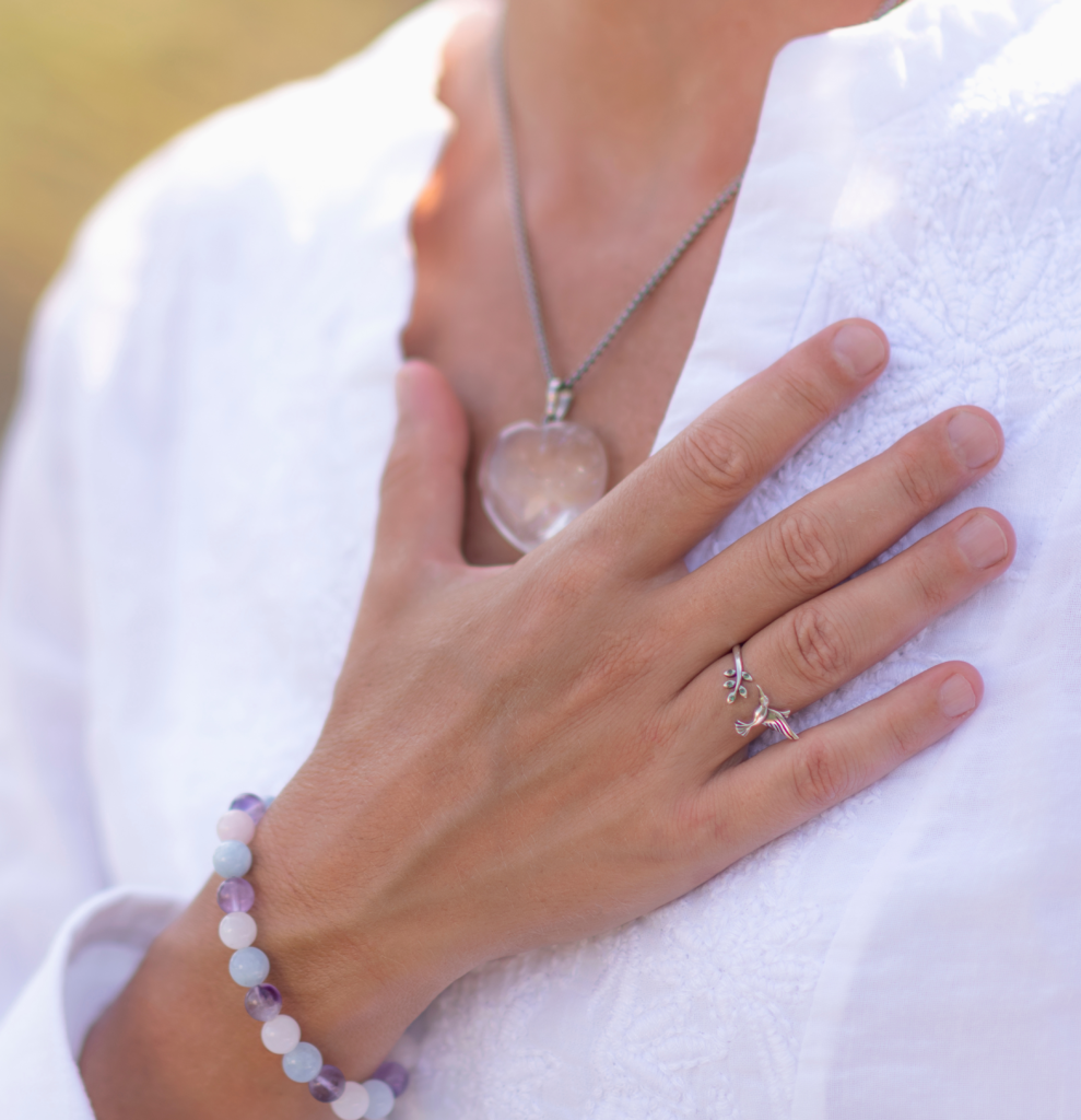 Woman's hand on heart chakra